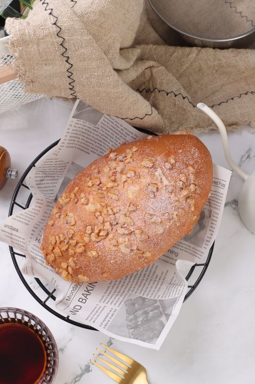 Free Delicious walnut-topped loaf on a wire basket with vintage style setup. Stock Photo