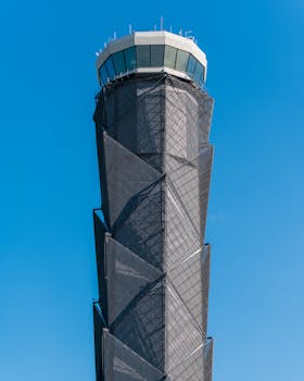 Contemporary air traffic control tower under blue skies in Zumpango de Ocampo, Mexico.