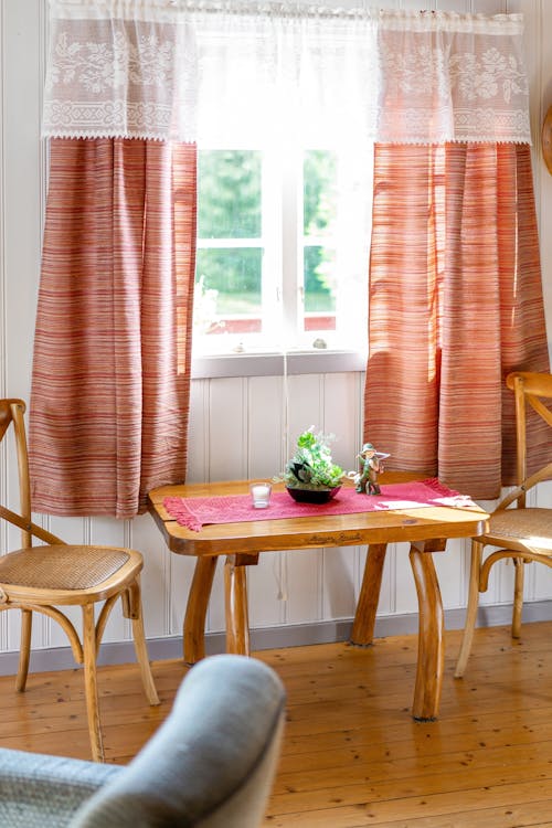 Wooden Table and Chairs near Windows