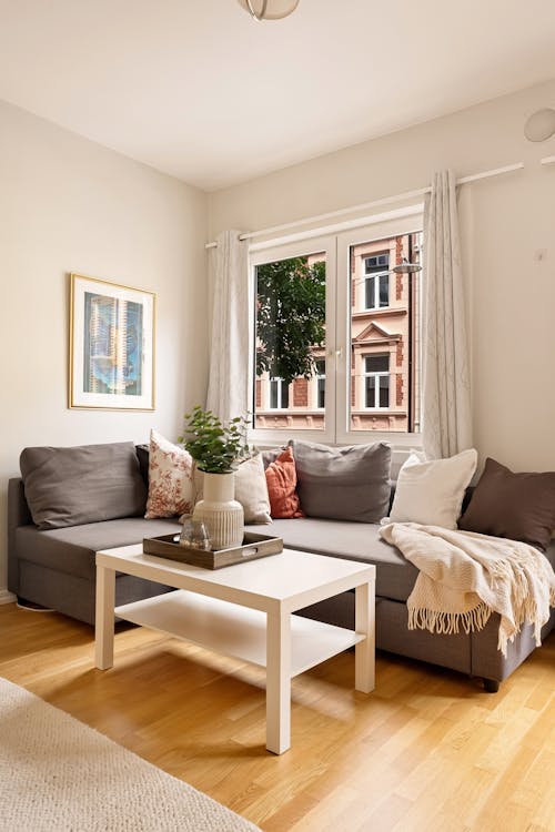 A living room with a couch, coffee table and window