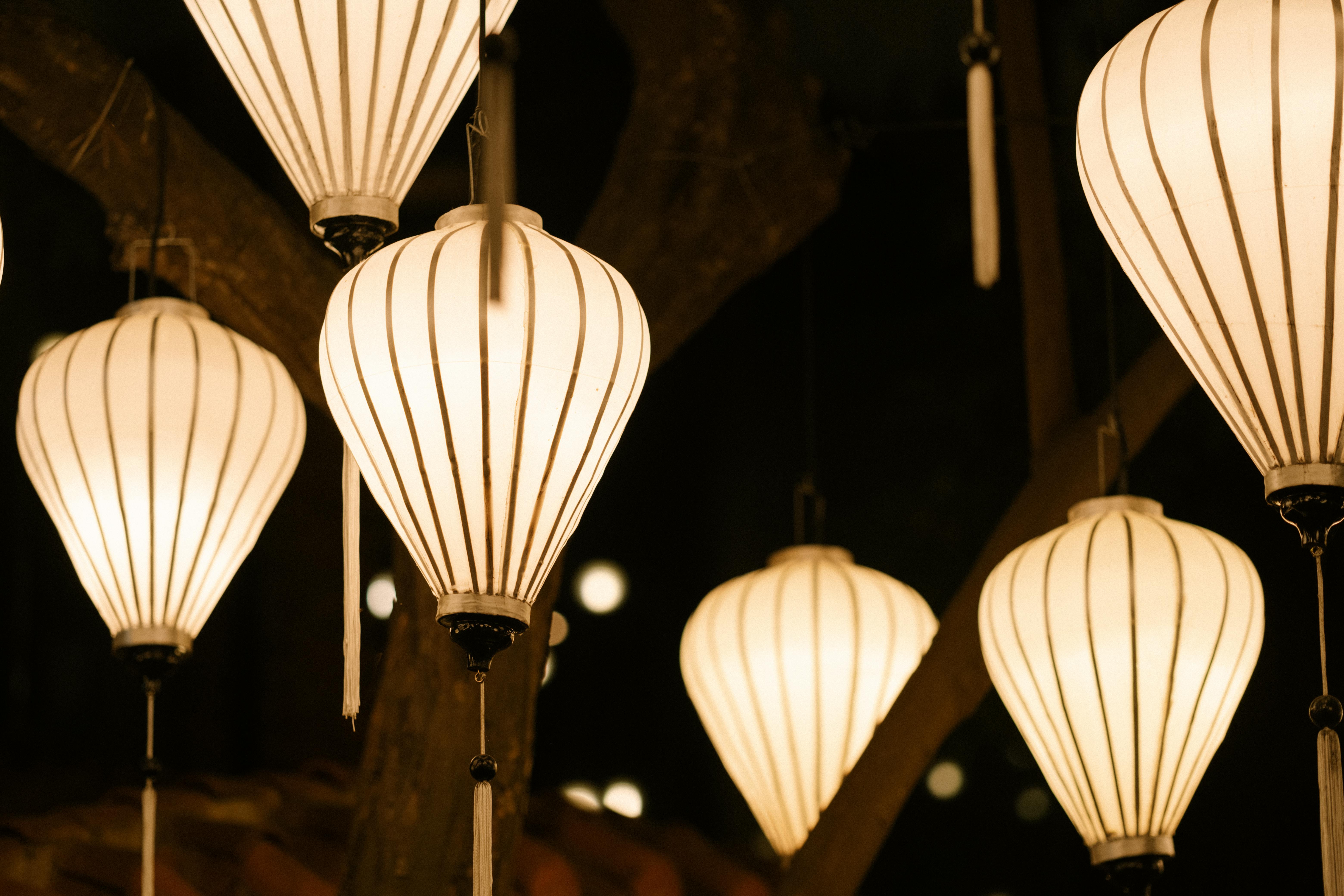 A close-up of elegant lanterns hanging in the night, creating a serene atmosphere.