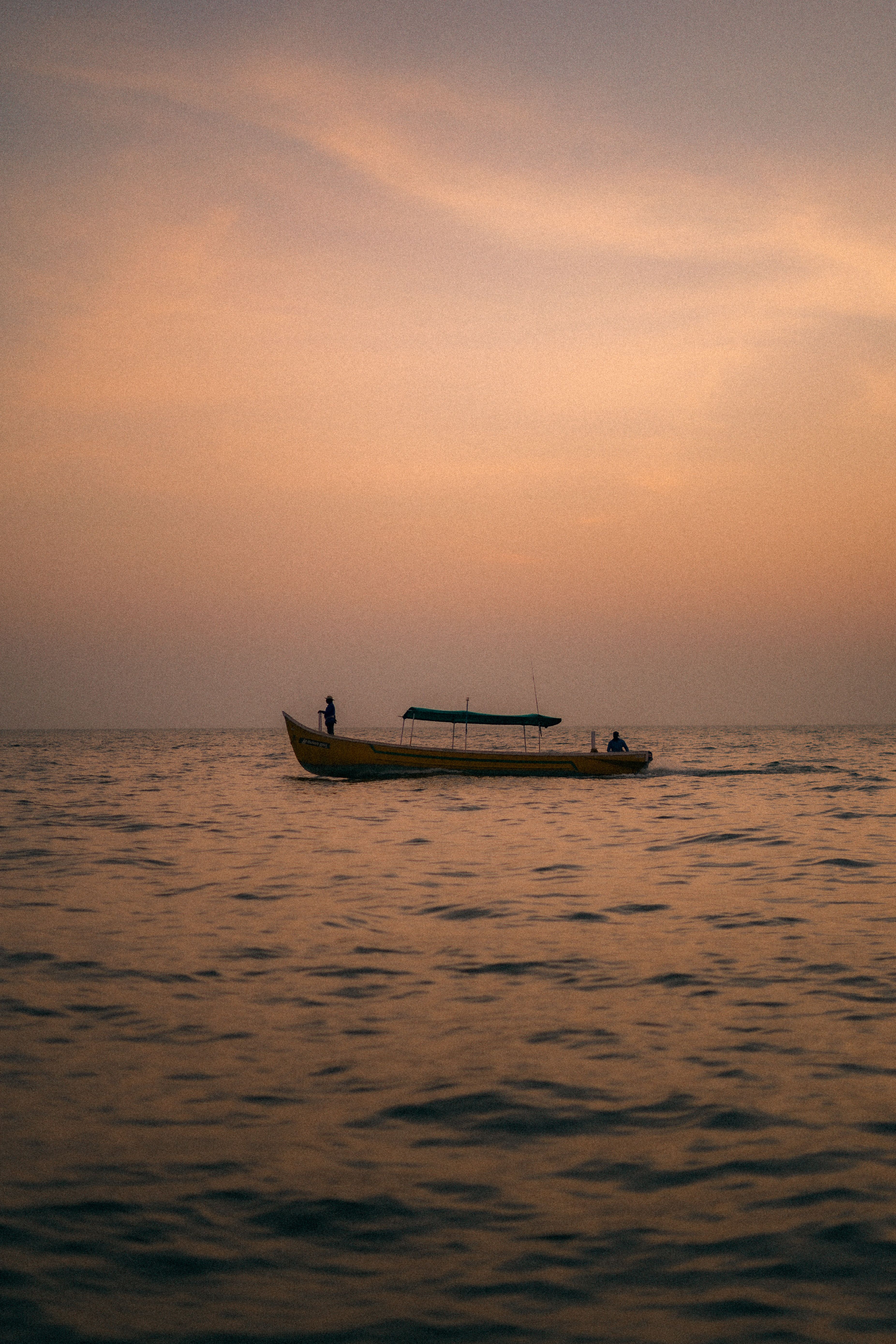 View of a Boat on a Body of Water at Sunset · Free Stock Photo