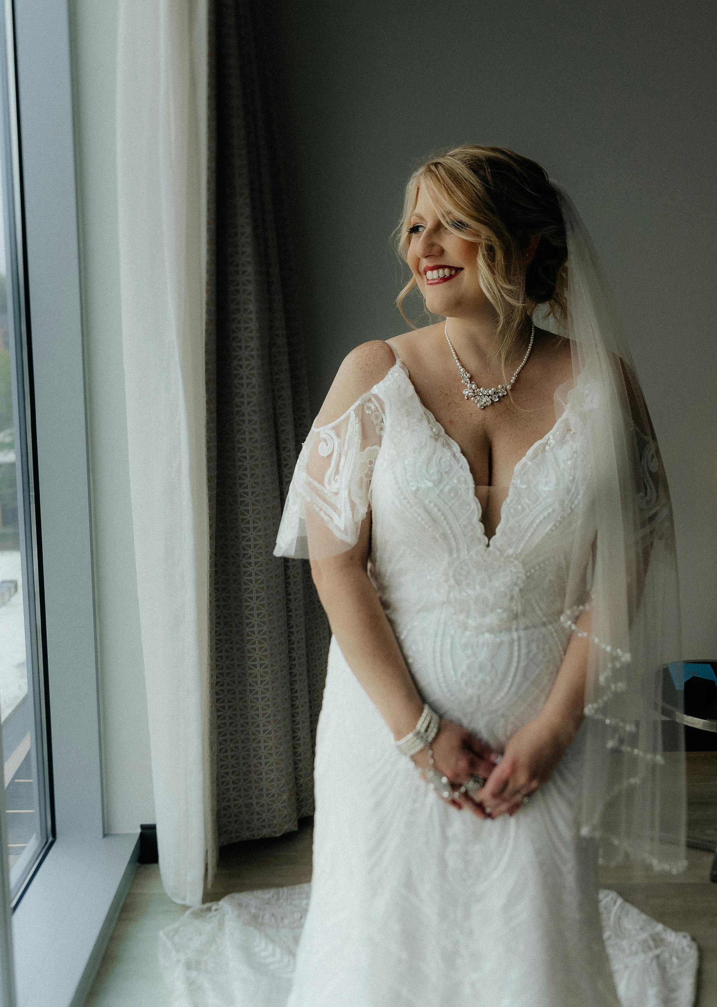 photo of a smiling bride standing in a room