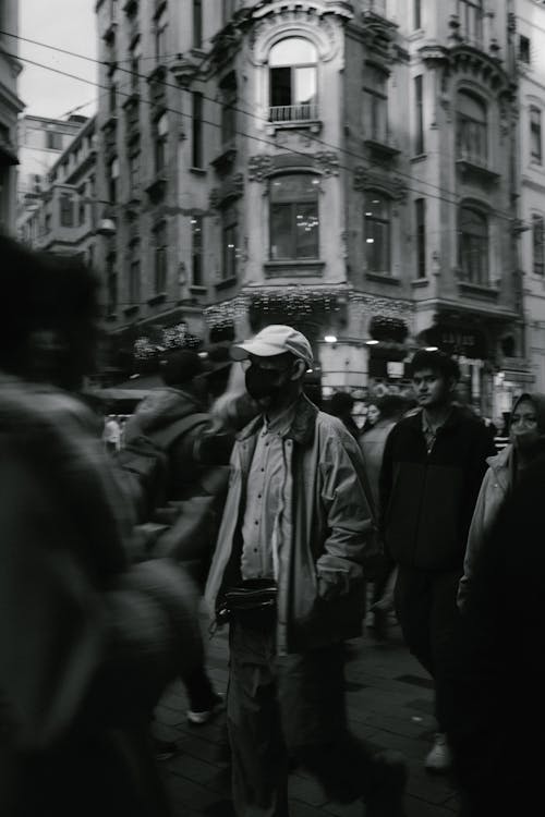 Black and White Photo of a Crowded Street in City 