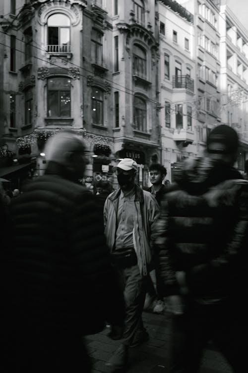 Black and White Photo of a Crowded Street in City 