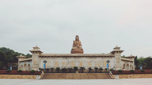 Free Facade of a Temple and Guanyin of Mount Xiqiao in the Background Stock Photo