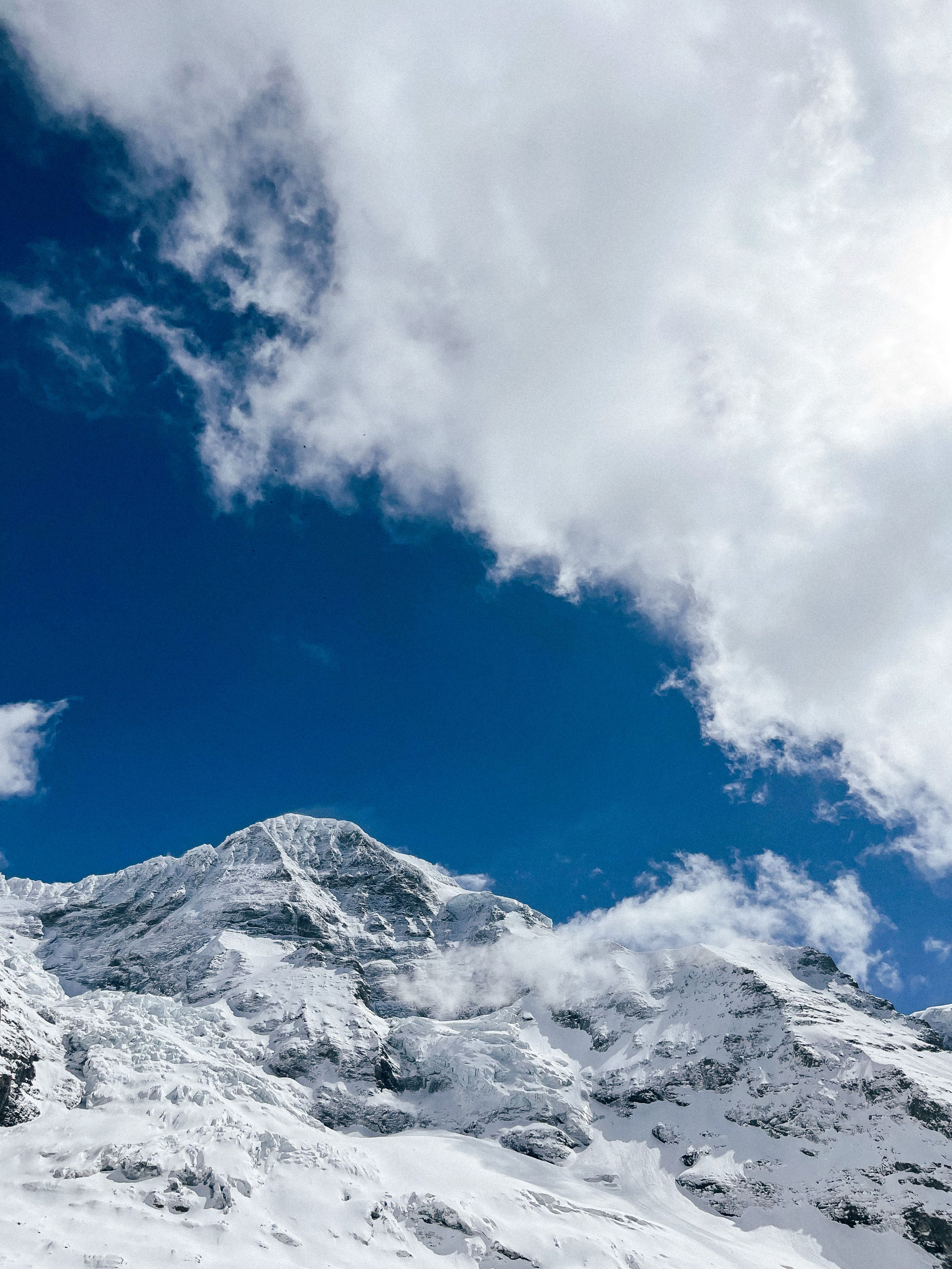 View of a Snowy Mountain Peak under Blue Sky with White Clouds · Free ...