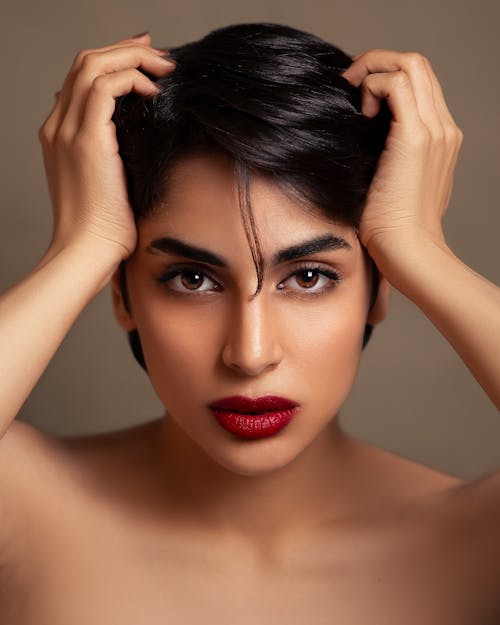 Portrait of a Young Brunette Wearing a Red Lipstick 