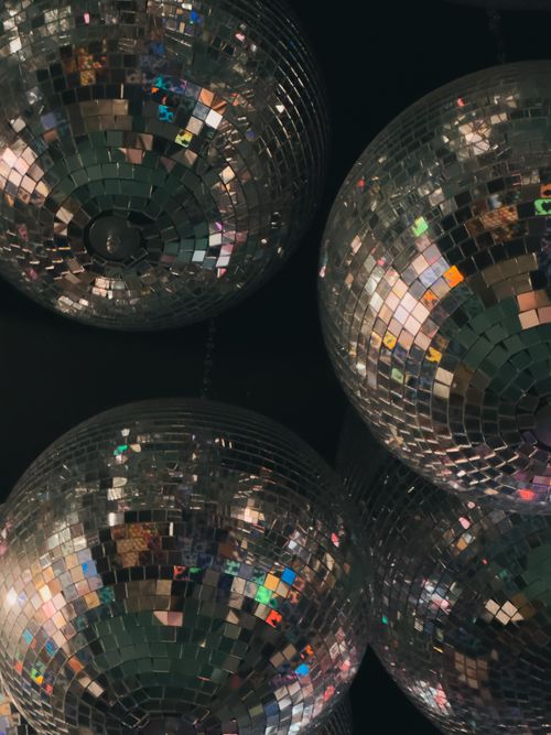 Free Shimmering disco balls create a vibrant nightlife ambiance indoors. Stock Photo