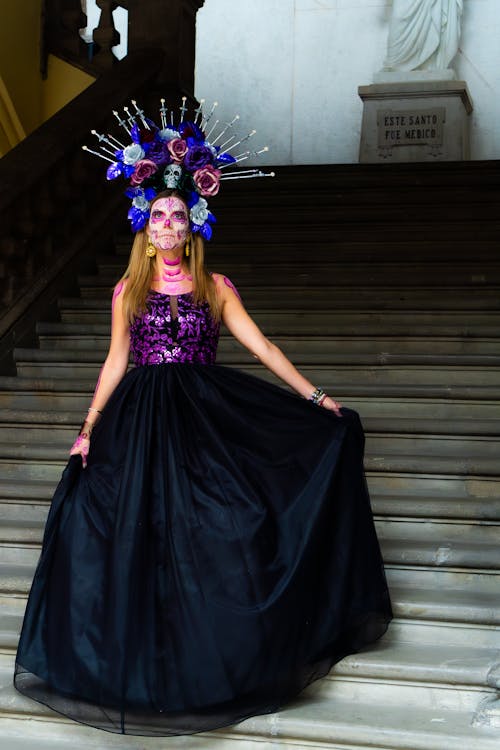 Woman in Makeup and Costume for Dia de Muertos Posing on Stairs