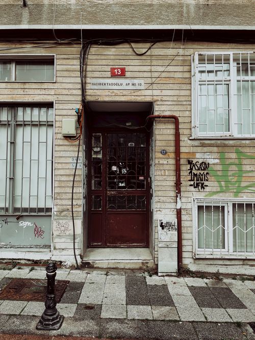 Free Exterior view of an urban building facade with graffiti and weathered elements. Stock Photo