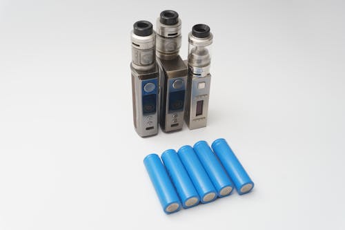 e-cigarettes and batteries  isolated on a white background
