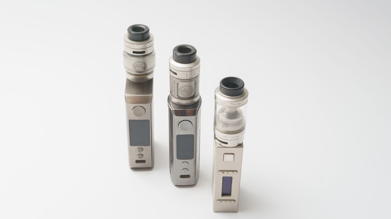 Three sleek vape devices displayed on a clean white background, showcasing advanced technology and design.