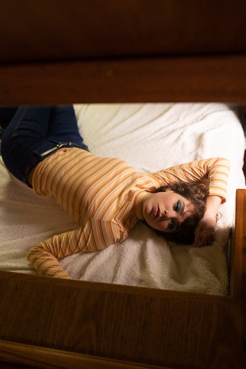 Free Woman Lying on Bed Stock Photo