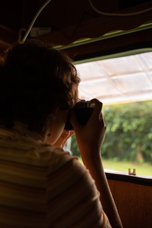 Woman Holding Camera and Taking Photo