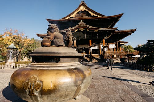 A statue of a cat sitting on top of a vase