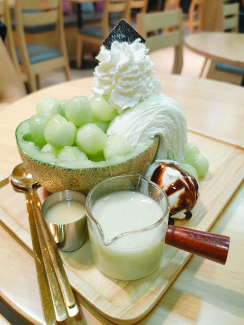 Melon Bingsu - a Korean Shaved Ice Dessert Served on a Tray in a Restaurant 