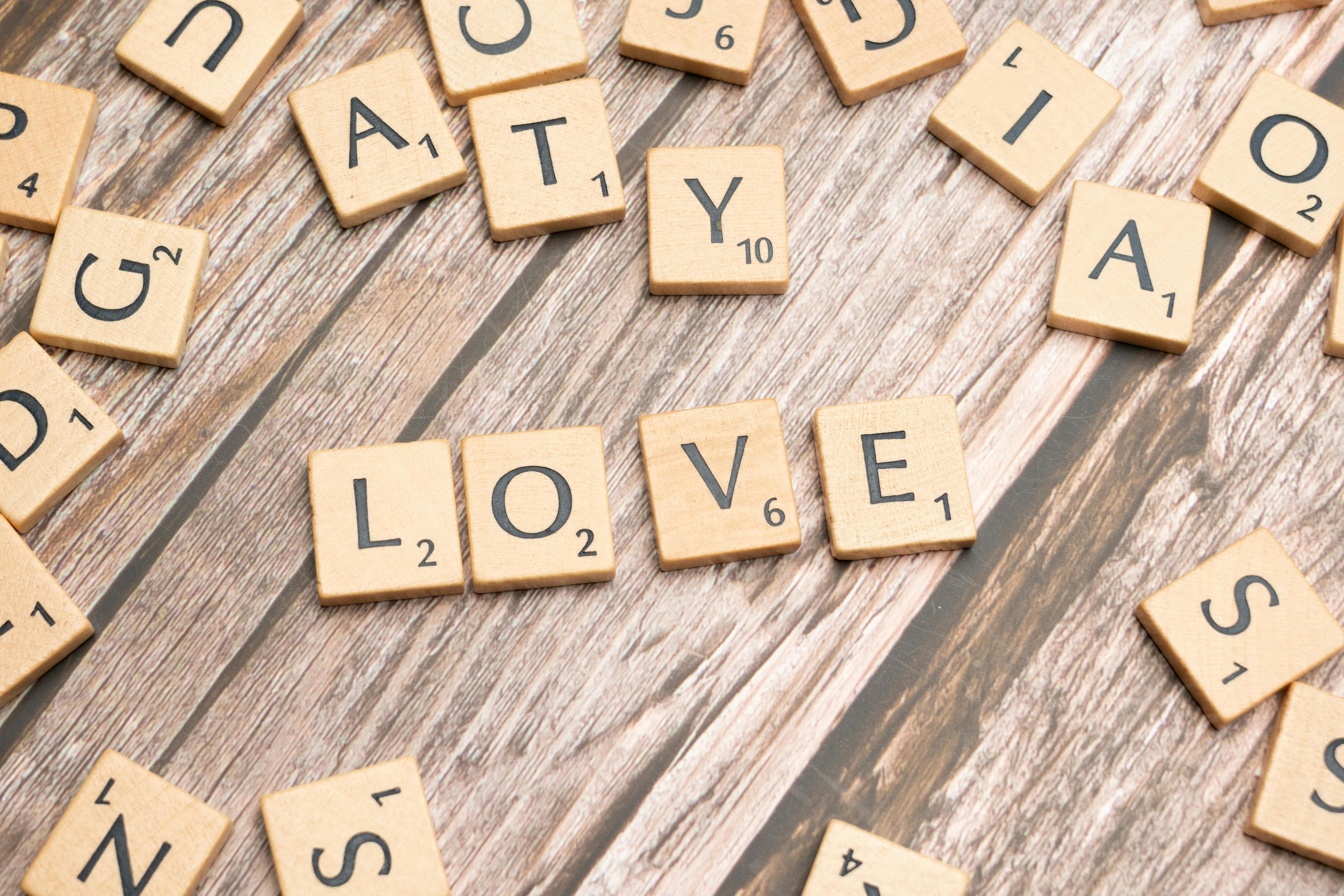 scrabble letters spelling love on a wooden table