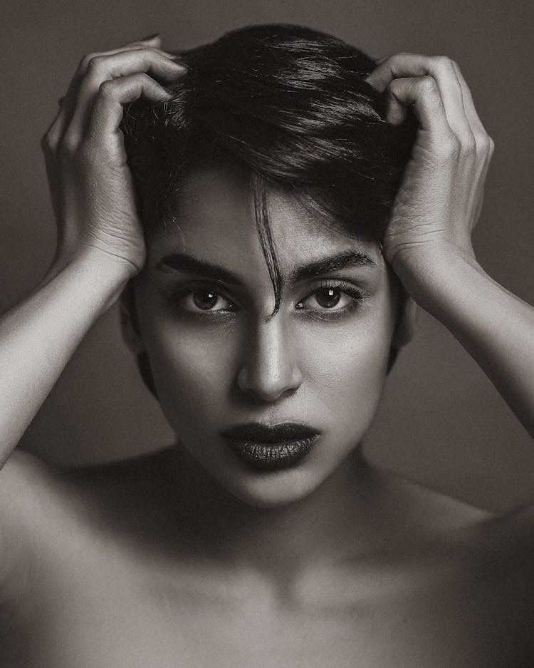 Beautiful Brunette Woman Fixing Hair