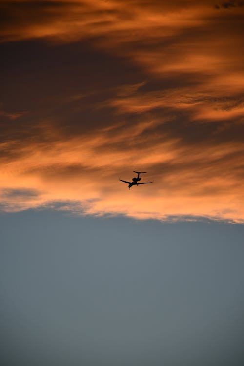 Airplane under Cloud at Sunset