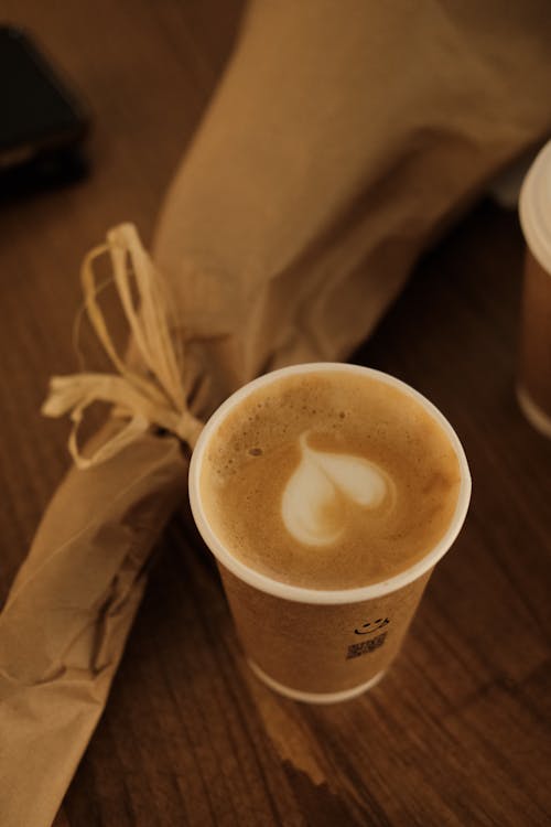 A Cup of Coffee an a Bouquet on a Table 