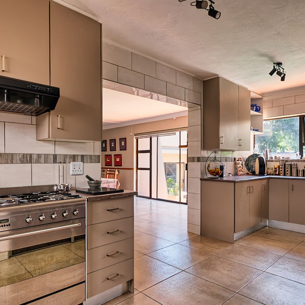 Kitchen Spraying in Merton Park — a decorator at work mid-project