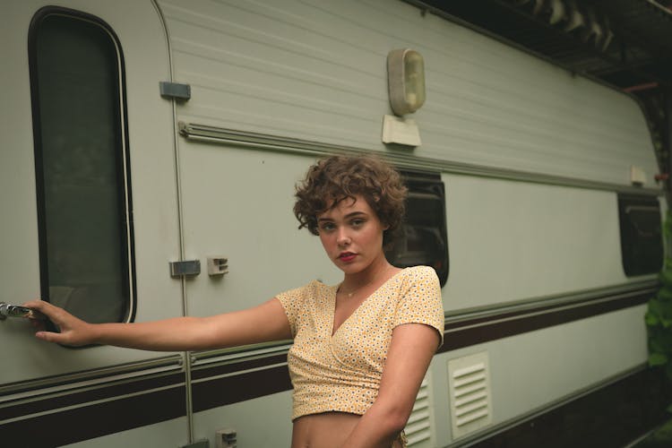 Woman Standing Beside Camper Trailer