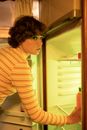 Woman Taking Bottle of Drink from Refrigerator