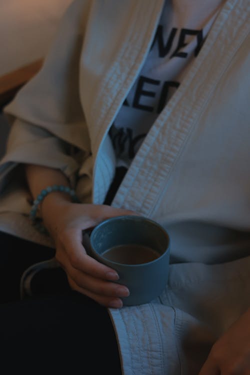Close up of Woman Sitting with Coffee Cup