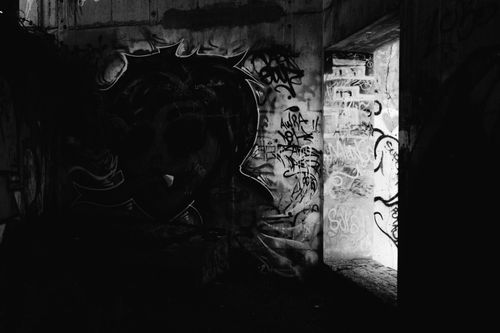 Free A dark tunnel with vibrant graffiti under dramatic shadows in Bariloche, Argentina. Stock Photo