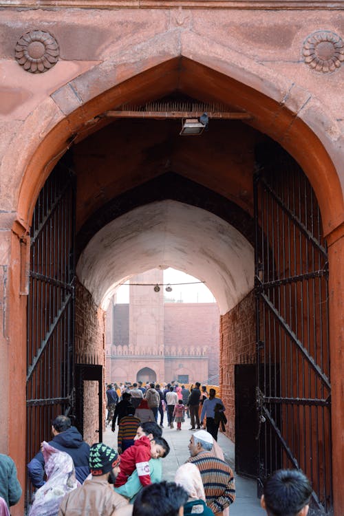 People in Front of an Entrance to a Mosque 