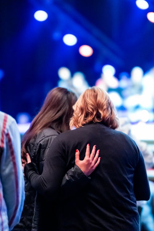 Women Standing Together at Concert