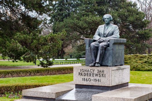 Statue of Ignacy Jan Paderewski in a serene Warsaw park during summer.