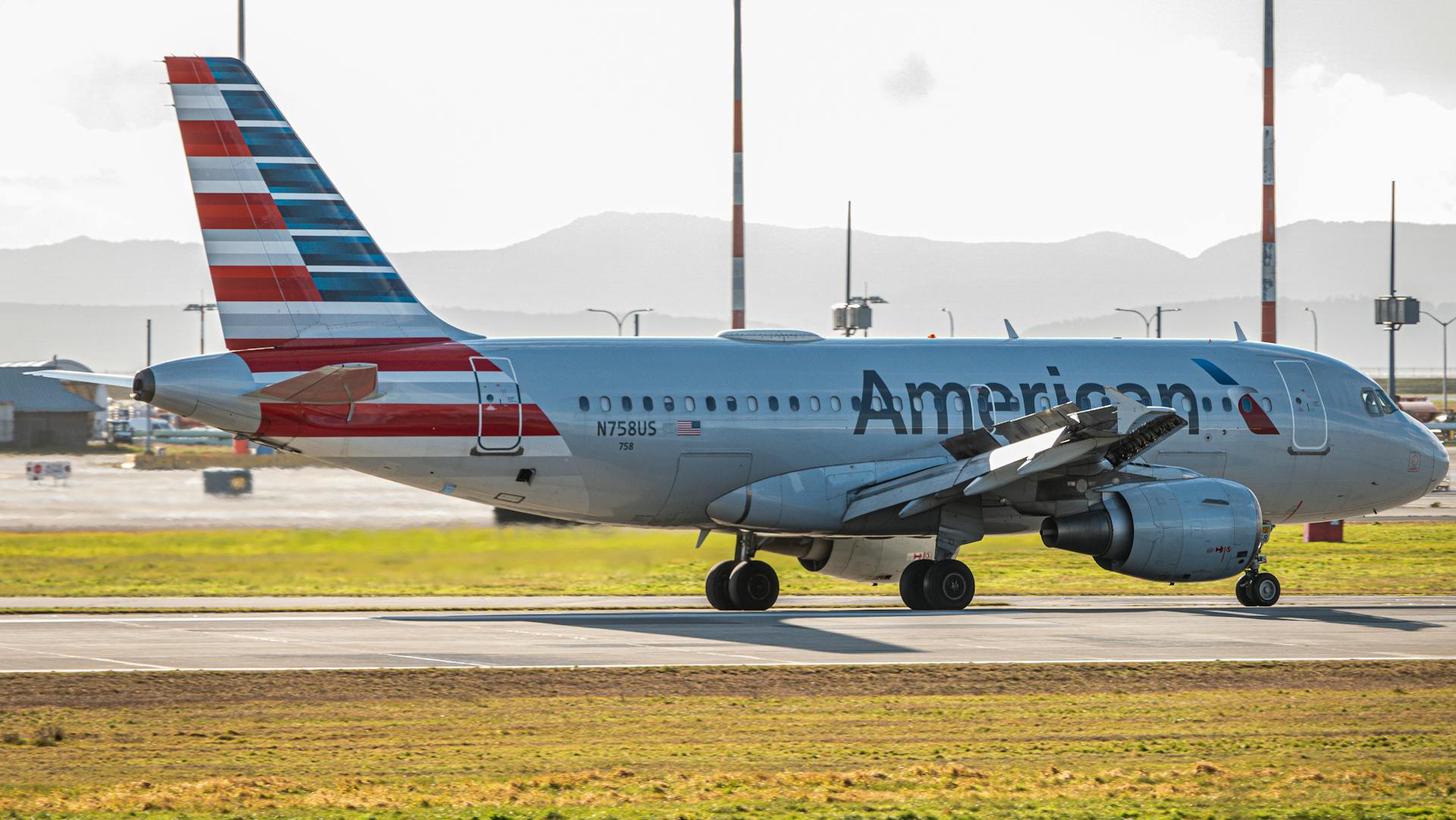 American Airlines airplane on the tarmac during daylight, featuring bright colors and clear aviation details.