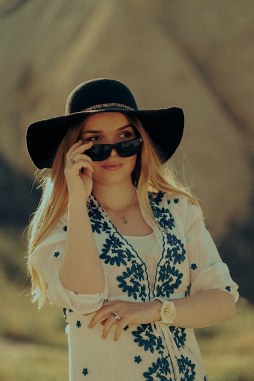 Portrait of Woman Wearing Sunglasses and Hat 