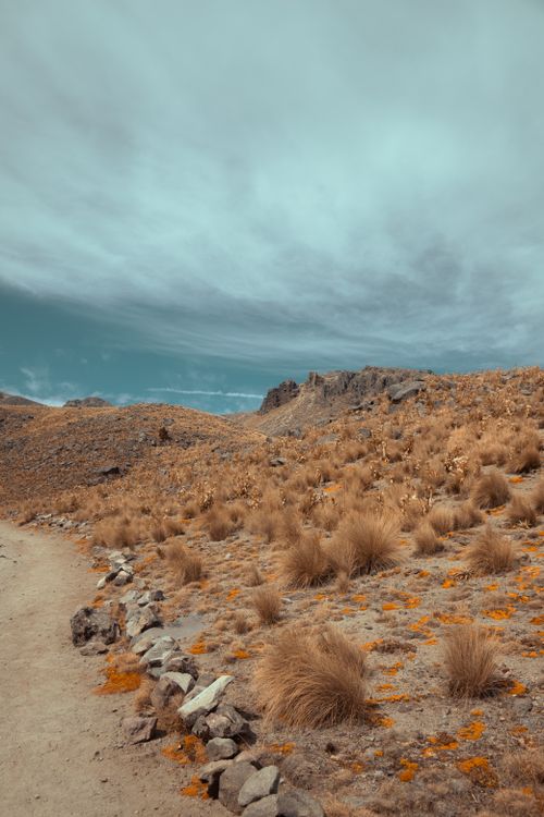 Free Stunning arid landscape near Ciudad de México with a prominent footpath under a cloudy sky. Stock Photo