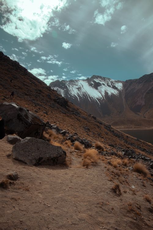 Free Scenic mountain landscape of Nevado de Toluca in Ciudad de México, showcasing arid terrain under partly cloudy skies. Stock Photo