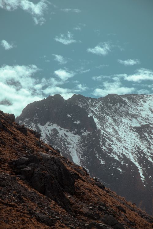Free Serene view of snow-covered mountains and rocks against a blue cloudy sky in Mexico. Stock Photo
