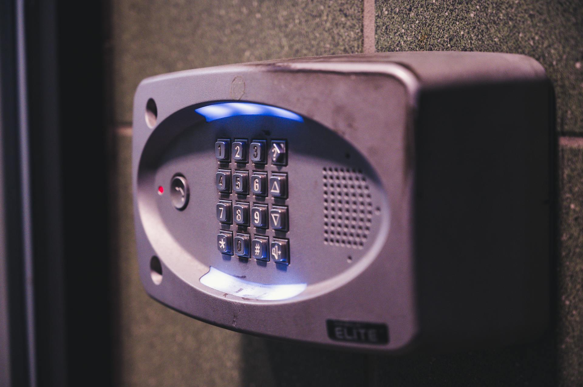 A close-up image of an illuminated security keypad mounted on a wall.