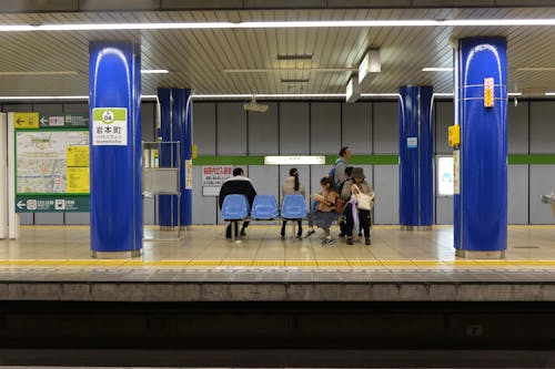People Sitting at Metro Station in Japan