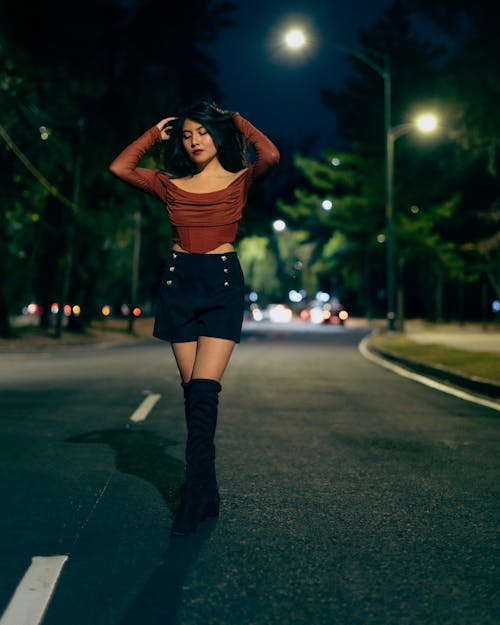 Brunette Woman on Street at Night