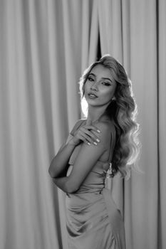 Stylish black and white portrait of a woman in elegant fashion with long hair.