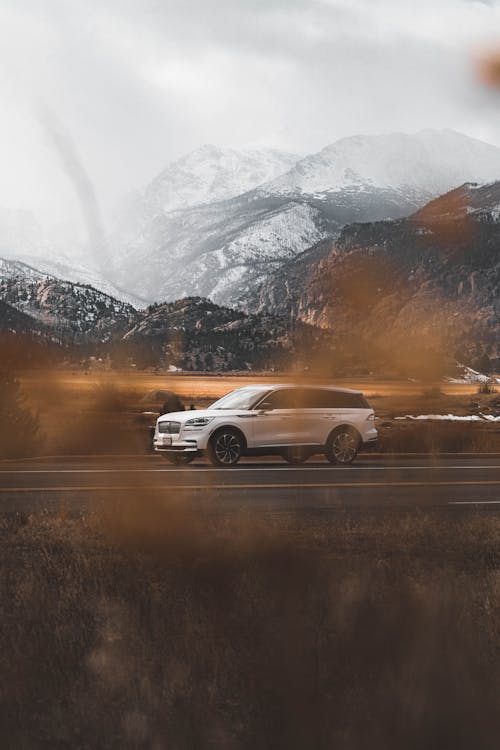 A White Lincoln Aviator SUV Driving in Mountains 
