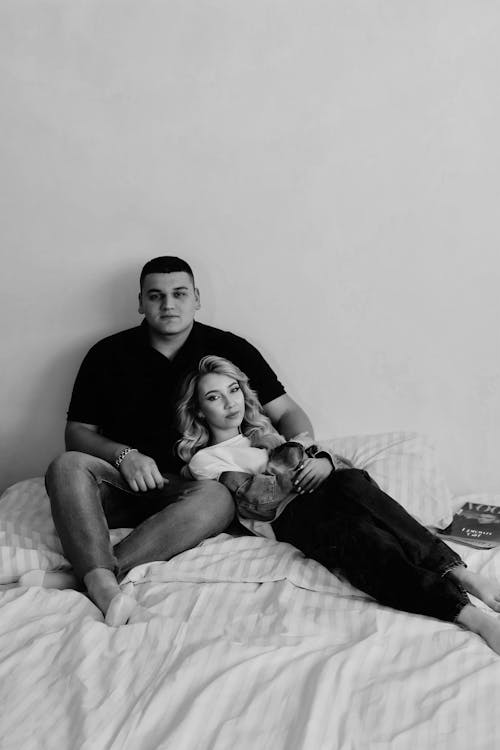 Free Young Couple Embracing on a Bed  Stock Photo