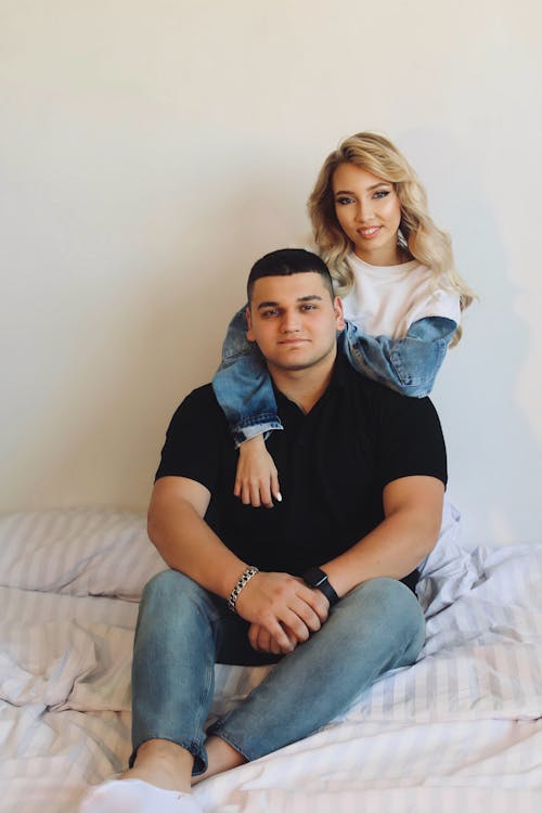 Free Young Couple Embracing on a Bed  Stock Photo