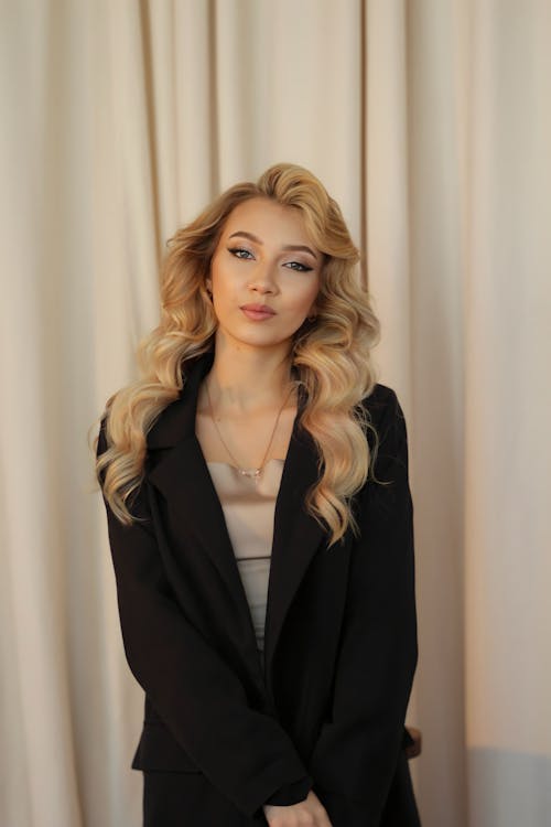 Young Elegant Woman with Wavy Hair wearing a Black Jacket 