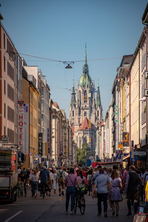 Free Urban scene in Munich showing St. Paul's Church and crowded streets under clear skies. Stock Photo
