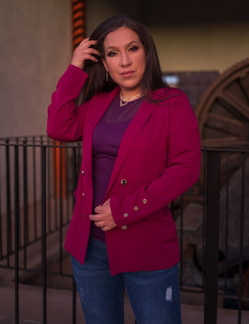 Elegant woman in jeans and pink blazer, confident office outfit