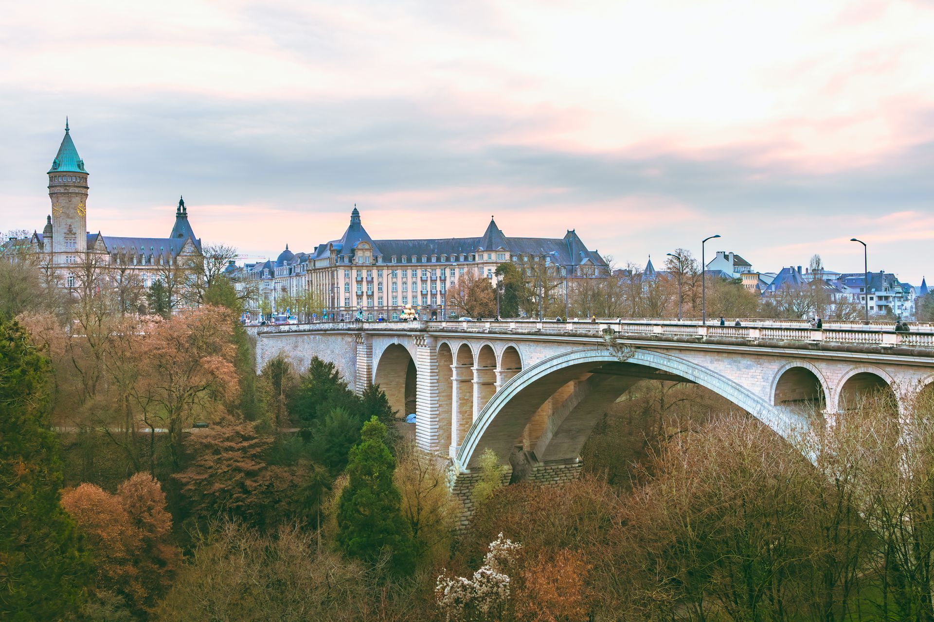 The iconic Adolphe Bridge in Luxembourg City surrounded by autumn foliage