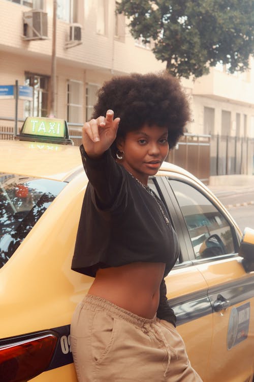 Portrait of Woman Standing by Taxi